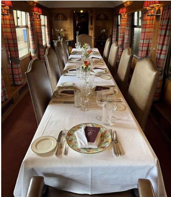 Private dining carriage with long formal table and plaid window dressings
